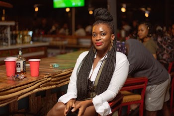Woman Wearing White Long-sleeved Top Sitting on Wooden Chair