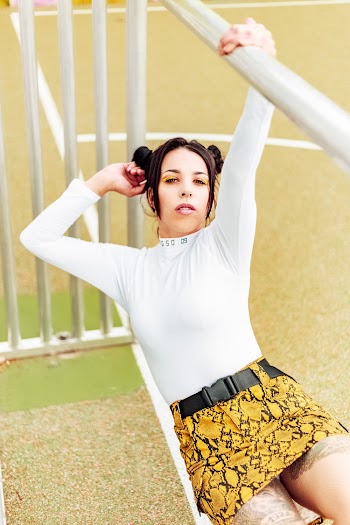 Woman Wearing White Long Sleeves With Yellow Mini Skirt