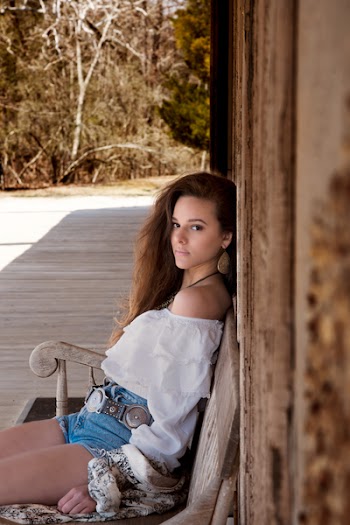 Woman Wearing White Off Shoulder Top Sitting on Bench