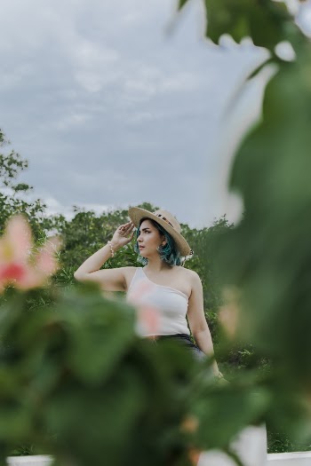 Woman Wearing White One-shoulder Dress and Brown Hat