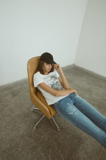 Woman Wearing White Printed Shirt Sitting on Brown Leather Rolling Chair