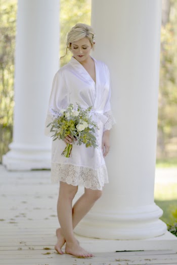 Woman Wearing White Robe While Holding Flowers