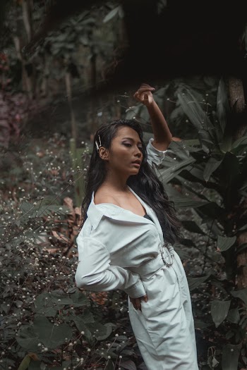Woman Wearing White Romper Standing Beside Plant