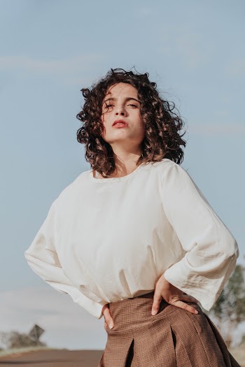Woman Wearing White Scoop-neck Long-sleeved Shirt and Brown Pleated Skirt