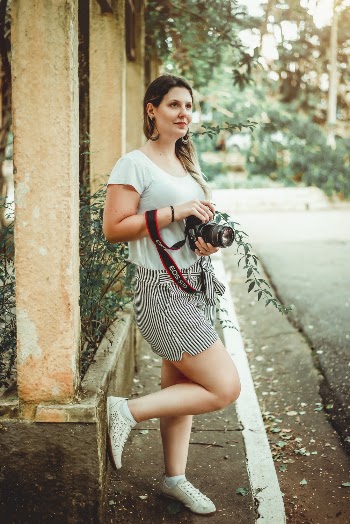 Woman Wearing White Scoop-neck Shirt and Gray Mini Skirt Holding Dslr Camera