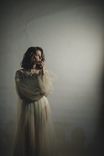 Woman Wearing White See Through Long Sleeved Dress 