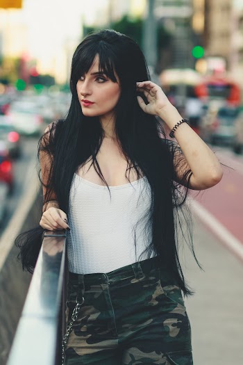 Woman Wearing White Shirt and Camouflage Bottoms
