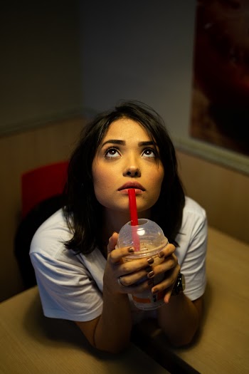 Woman Wearing White Shirt Holding A Drink