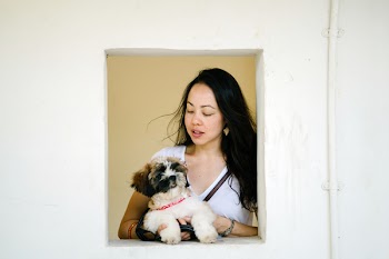 Woman Wearing White Shirt Holding Puppy