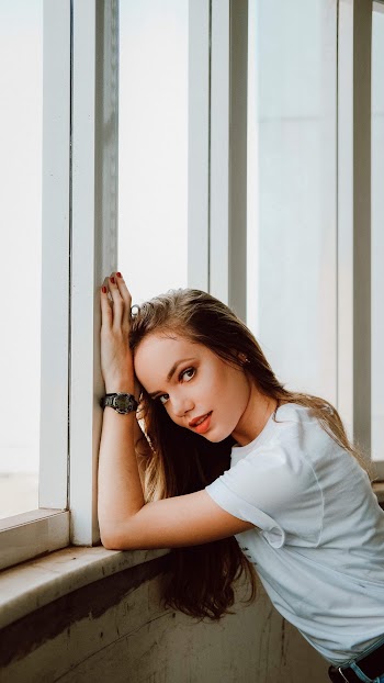 Woman Wearing White Shirt Leaning on Glass Window