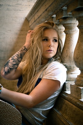Woman Wearing White Shirt Leaning on Railing