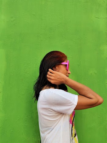 Woman Wearing White Shirt Standing Near Green Wall