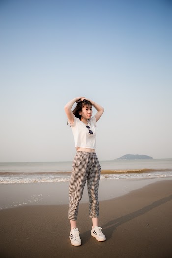 Woman Wearing White Shirt Standing on Sand