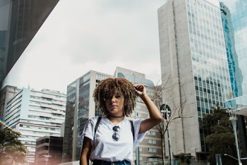 Woman Wearing White Shirt Standing Outside With View of Building