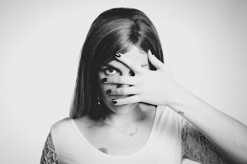 Woman Wearing White Shirt With Hand on Her Face