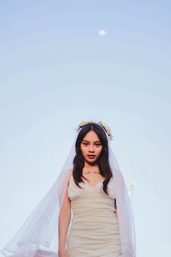 Woman Wearing White Sleeveless Dress and a Veil 
