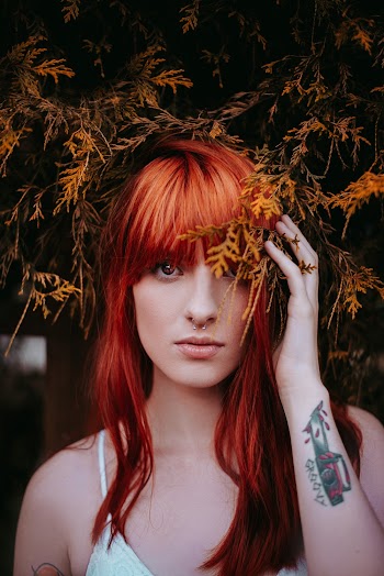 Woman Wearing White Spaghetti-strap Top Holding Leaves