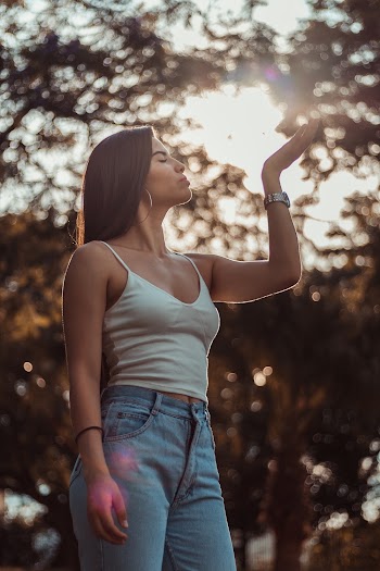 Woman Wearing White Spaghetti Strap Top Raising Hand