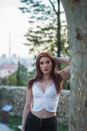 Woman Wearing White Spaghetti Strap V-neck Top and Black Denim Bottoms