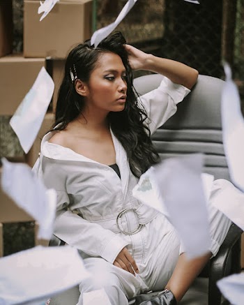 Woman Wearing White Suit Sitting on Chair