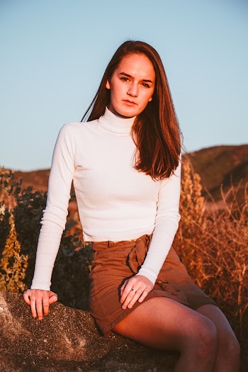 Woman Wearing White Sweater and Brown Denim Skirt