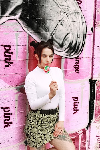 Woman Wearing White Sweater Eating Lollipop