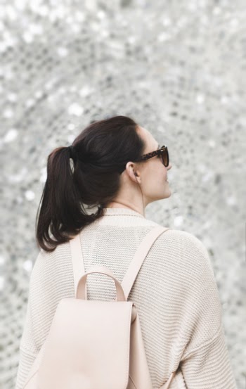 Woman Wearing White Sweatshirt and Backpack
