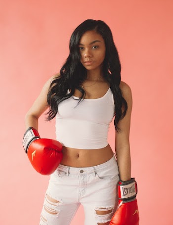 Woman Wearing White Tank Top and Red Boxing Gloves
