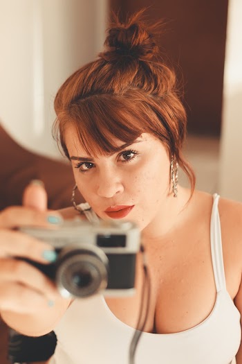 Woman Wearing White Tank Top Holding Dslr Camera