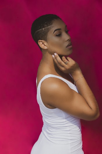 Woman Wearing White Tank Top Holding Jaw