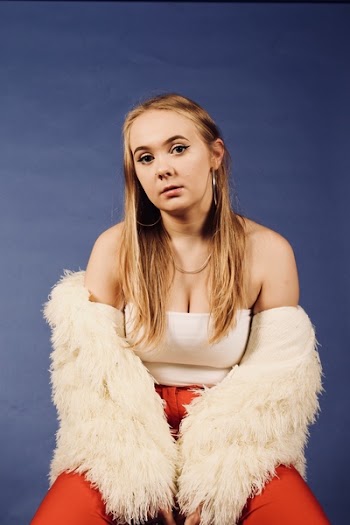 Woman Wearing White Top and Beige Coat