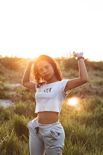 Woman Wearing White Top and Gray Pants