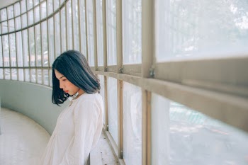 Woman Wearing White Top Beside Window at Daytime