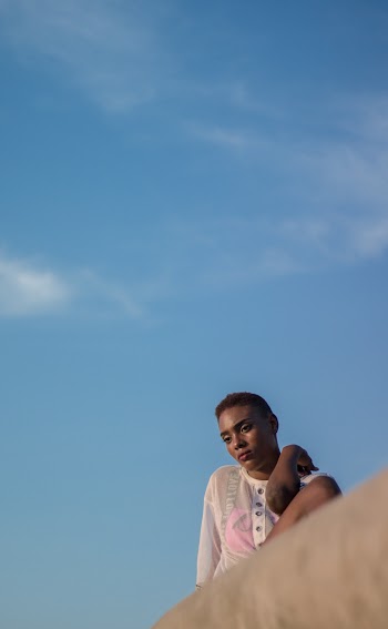 Woman Wearing White Top Looking Down