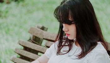 Woman Wearing White Top Sitting on Bench