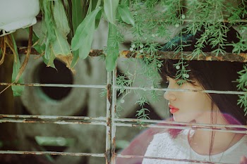 Woman Wearing White Top Watches in the Window