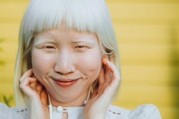 woman wearing white top while making face