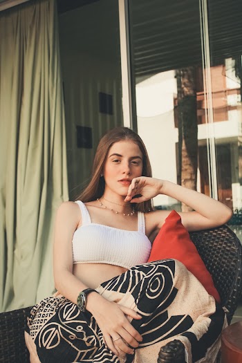 Woman Wearing White Tube Top Sitting on Wicker Chair