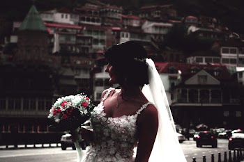 Woman Wearing White Wedding Gown Holding Flower Bouquet