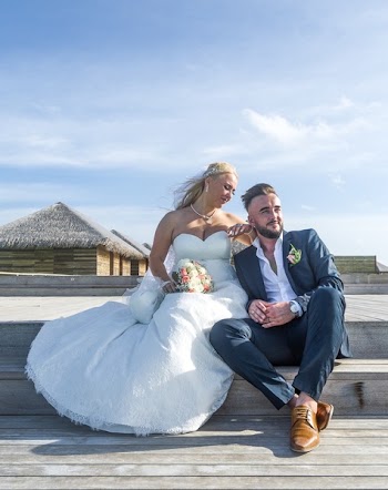 Woman Wearing White Wedding Gown Sitting Near Man Wearing Black Suit Jacket and Pants