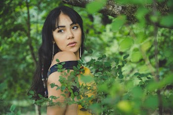 Woman Wearing Yellow and Black Dress Looking at Side