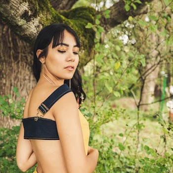 Woman Wearing Yellow And Blue Denim Top Standing Under The Tree
