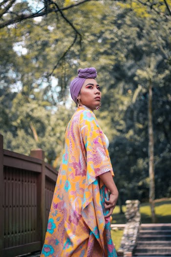 Woman Wearing Yellow and Purple Floral Dress Standing Outdoor