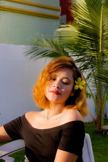 Woman Wearing Yellow Bell Sitting on White Chair