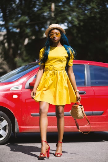 Woman Wearing Yellow Boat-neck Short-sleeved Dress Standing Near Red Car