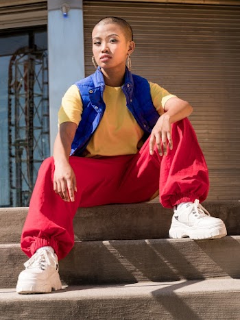 Woman Wearing Yellow Crew-neck T-shirt and Red Pants Sitting on Stairs