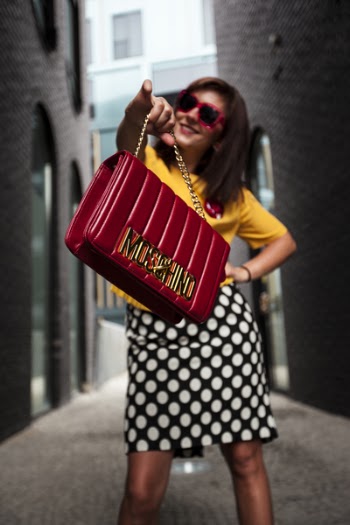 Woman Wearing Yellow Crew-neck T-shirt While Holding Red Handbag