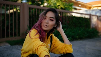 Woman Wearing Yellow Jacket Holding Her Hair