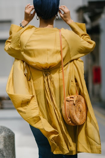 Woman Wearing Yellow Long-sleeved Dress Standing on Road