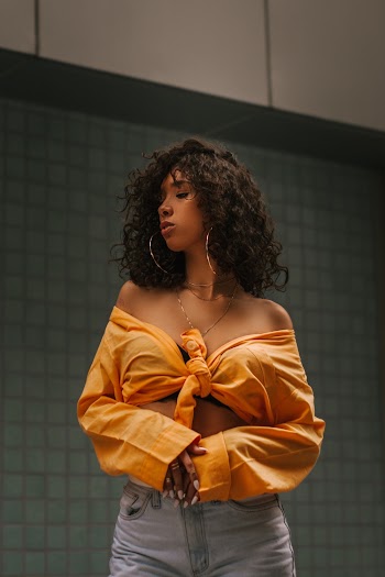 Woman Wearing Yellow Off-shoulder Long-sleeved Top And Grey Pants